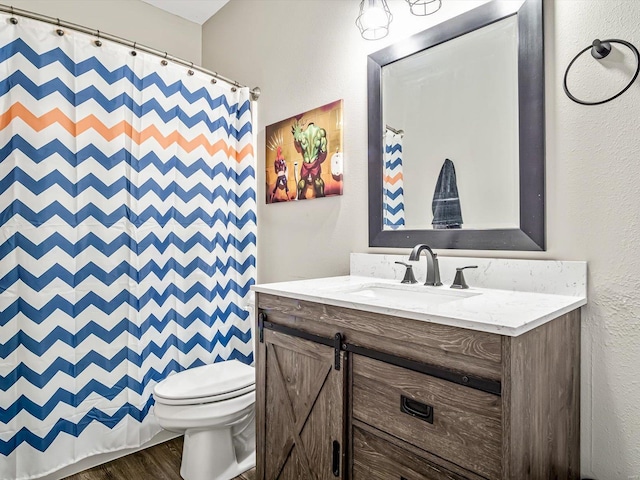 bathroom featuring hardwood / wood-style floors, vanity, and toilet