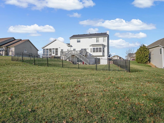 back of house with a lawn and a deck