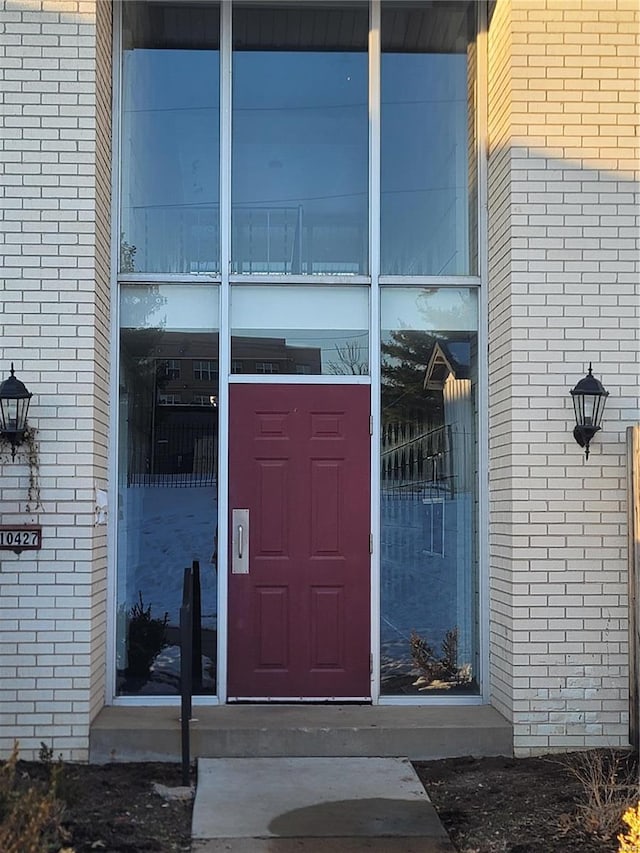 property entrance featuring brick siding