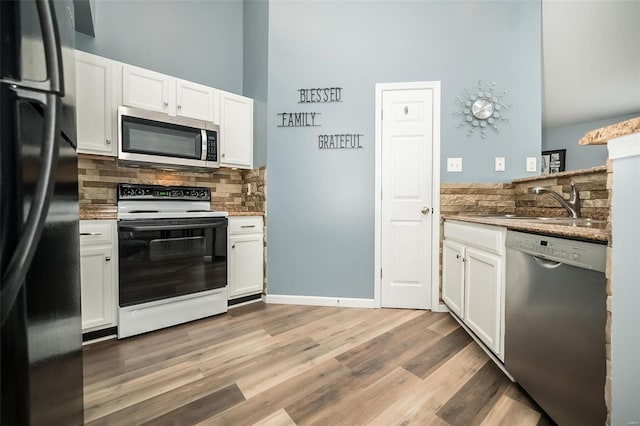 kitchen featuring white cabinetry, tasteful backsplash, appliances with stainless steel finishes, and a sink