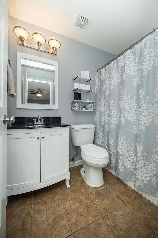 bathroom with visible vents, toilet, tile patterned flooring, baseboards, and vanity