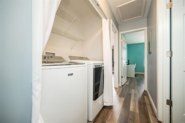 washroom with baseboards, laundry area, attic access, dark wood-type flooring, and washer and dryer