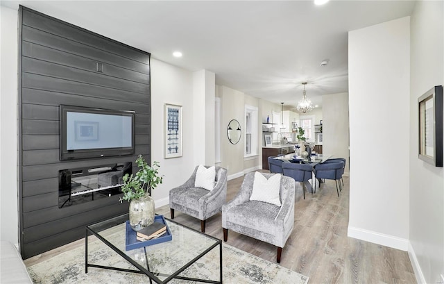 living room with an inviting chandelier and hardwood / wood-style floors