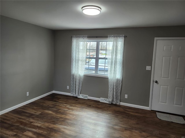 unfurnished room with dark hardwood / wood-style floors