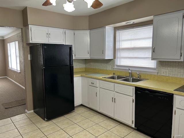 kitchen featuring ceiling fan, sink, black appliances, light tile patterned floors, and white cabinets