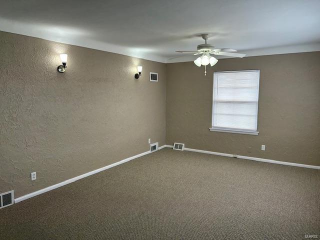 spare room featuring ceiling fan and carpet floors