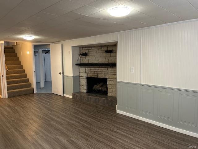 unfurnished living room featuring dark hardwood / wood-style flooring and a fireplace