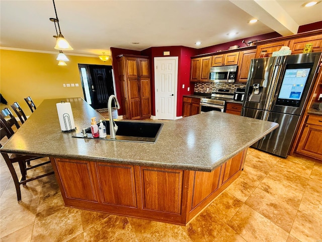 kitchen featuring a kitchen bar, appliances with stainless steel finishes, a large island, and sink