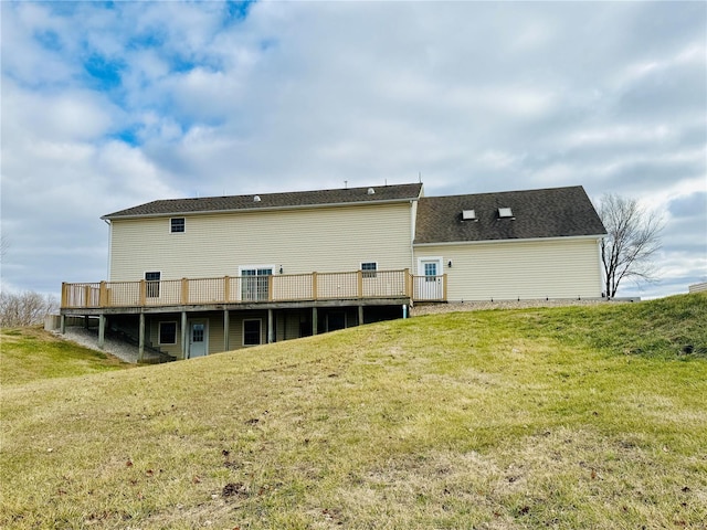 rear view of house with a yard and a wooden deck