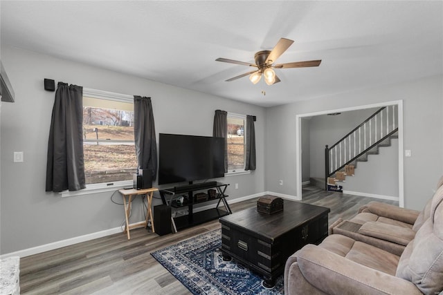 living room featuring dark hardwood / wood-style floors, plenty of natural light, and ceiling fan