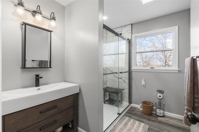 bathroom with hardwood / wood-style floors, vanity, and an enclosed shower