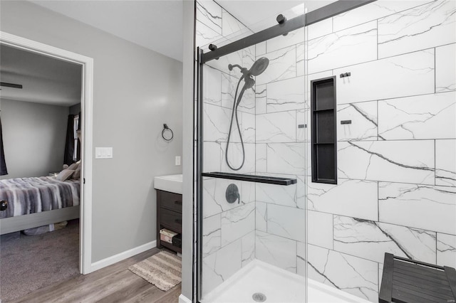 bathroom featuring hardwood / wood-style flooring, vanity, and walk in shower