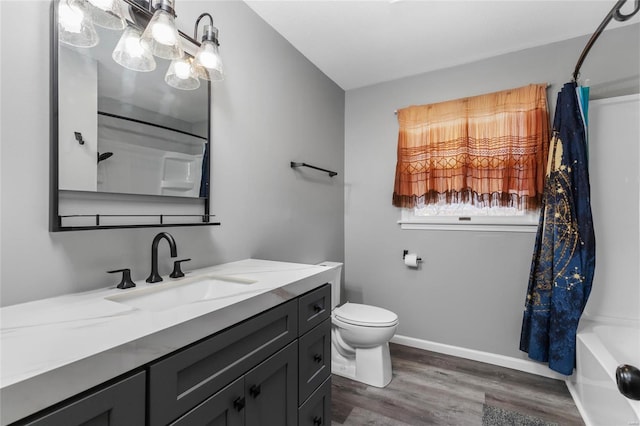 full bathroom with shower / tub combo with curtain, vanity, wood-type flooring, and toilet