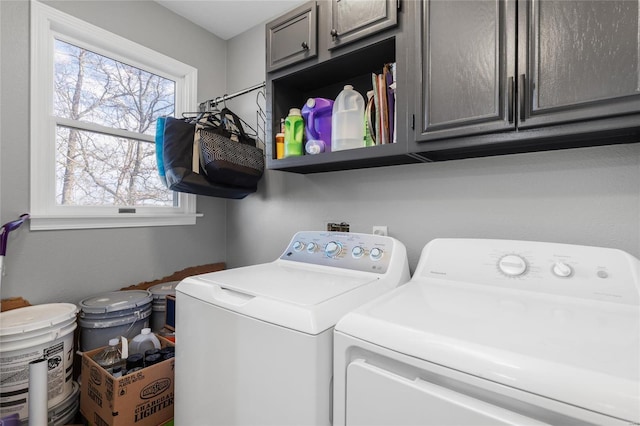 laundry room featuring cabinets and washing machine and clothes dryer