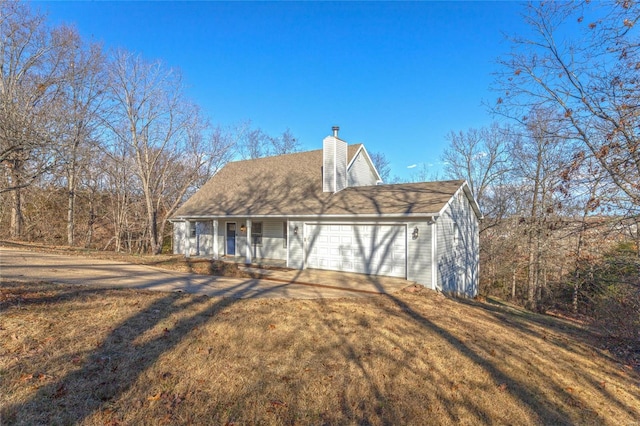 view of front of house with a garage and a front lawn