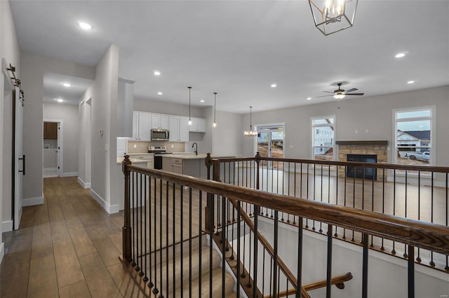 hall featuring hardwood / wood-style floors and an inviting chandelier