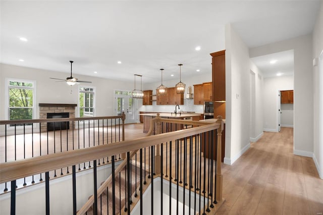 hall featuring sink and light wood-type flooring