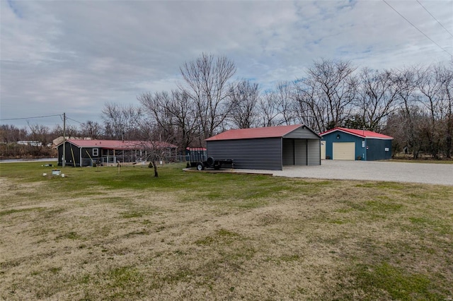 view of yard featuring a carport and an outdoor structure