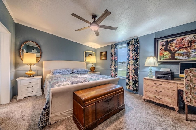 carpeted bedroom featuring a textured ceiling and ceiling fan