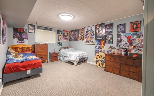 bedroom with carpet floors and a textured ceiling