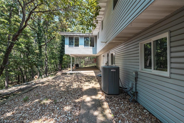 view of home's exterior with cooling unit and a patio area