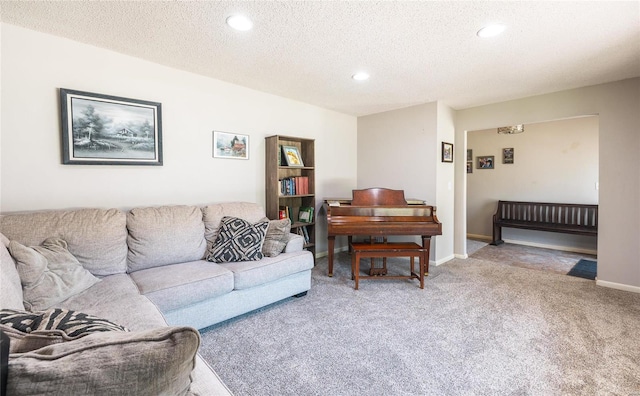 living room featuring carpet and a textured ceiling