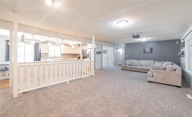 carpeted living room with a textured ceiling