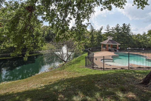 view of pool with a gazebo, a patio, a water view, and a yard