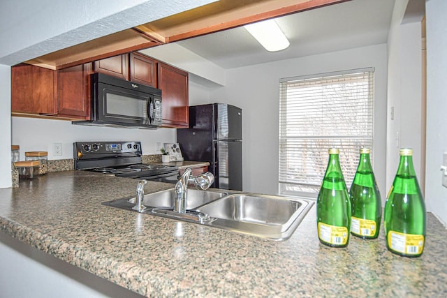 kitchen featuring kitchen peninsula, sink, and black appliances