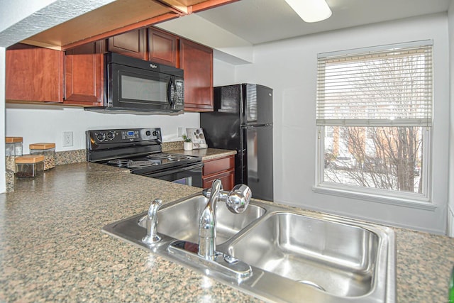 kitchen featuring sink, black appliances, and plenty of natural light