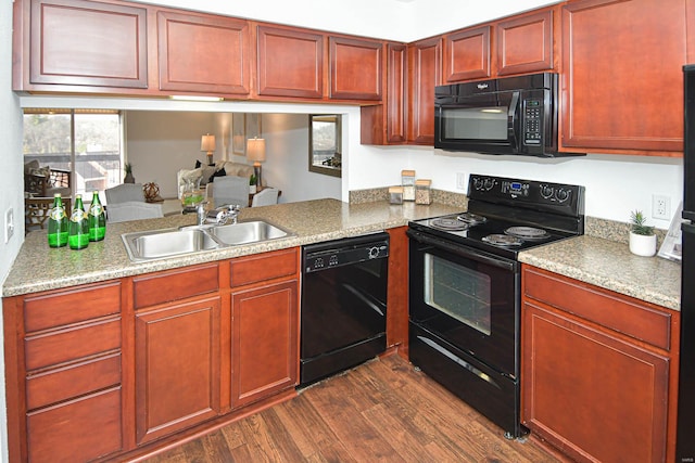 kitchen featuring sink, dark wood-type flooring, and black appliances