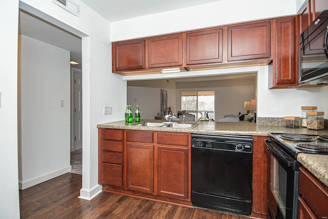 kitchen with dark hardwood / wood-style flooring, sink, light stone counters, and black appliances