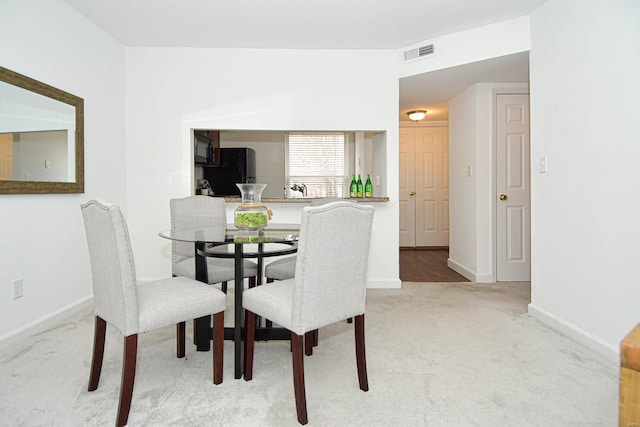 dining area with light carpet