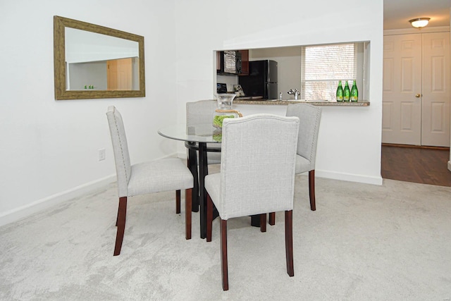 dining space with light carpet