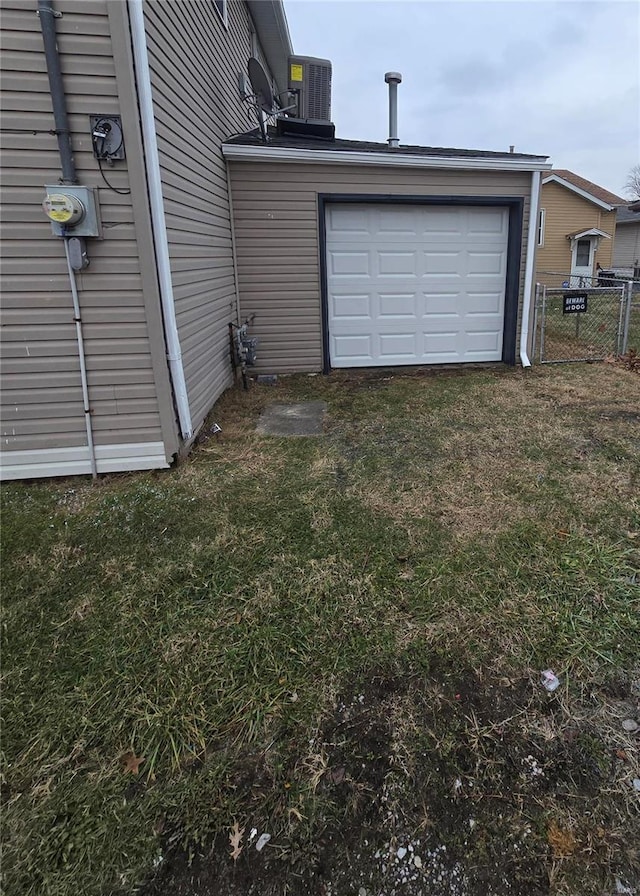 garage with a yard and central AC