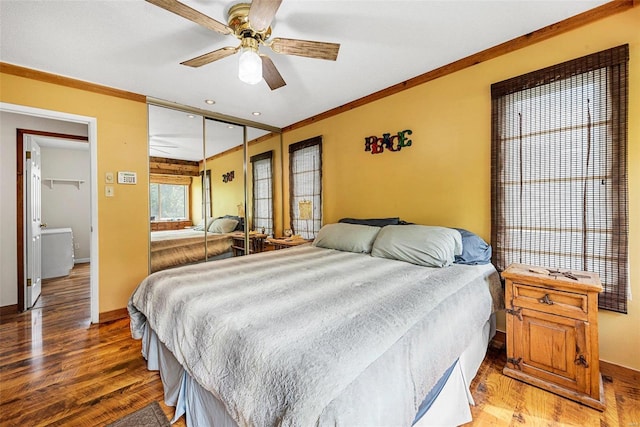 bedroom with ceiling fan, wood-type flooring, ornamental molding, and a closet