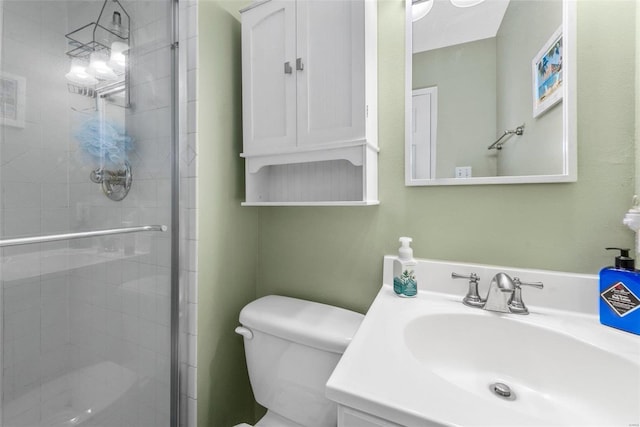 bathroom featuring vanity, toilet, and a shower with door