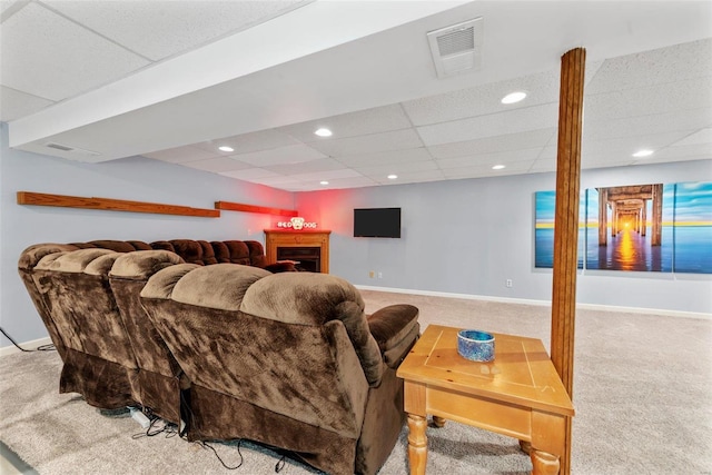 carpeted living room with a drop ceiling