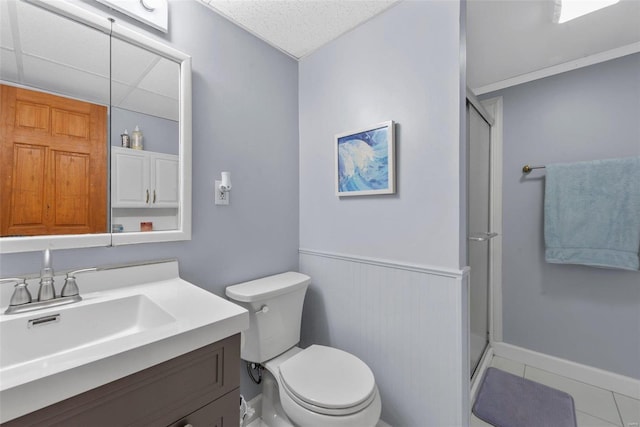 bathroom featuring tile patterned floors, vanity, toilet, and walk in shower