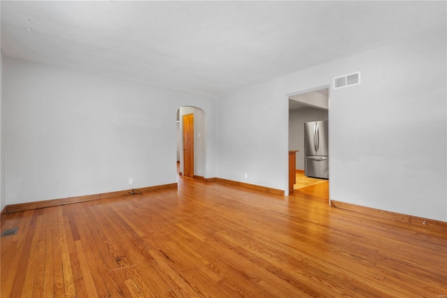 spare room with light hardwood / wood-style flooring