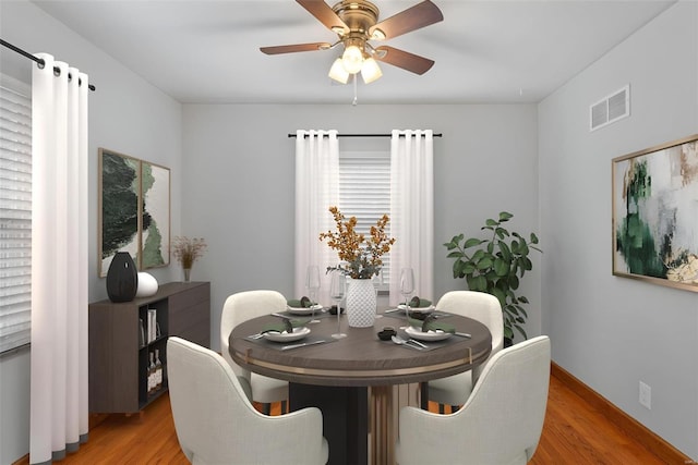 dining area featuring hardwood / wood-style floors and ceiling fan