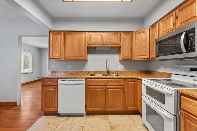 kitchen featuring white appliances and sink