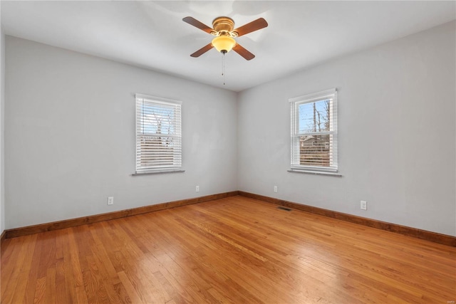 spare room featuring light hardwood / wood-style flooring, plenty of natural light, and ceiling fan