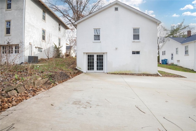 back of house featuring french doors and central AC