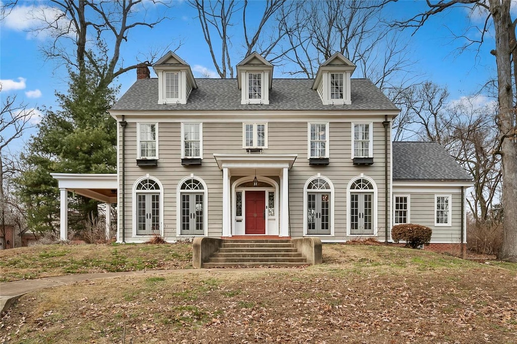 colonial inspired home featuring french doors