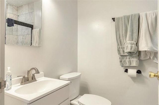 bathroom with vanity, an enclosed shower, and toilet