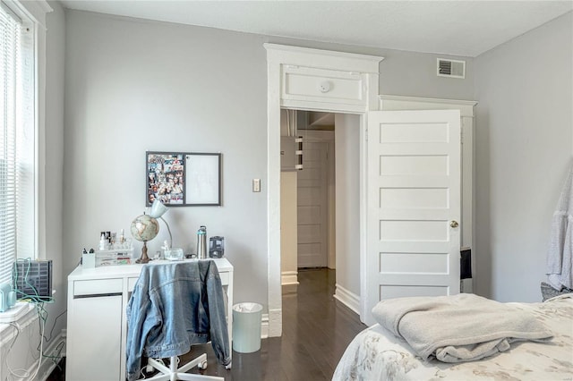 bedroom with dark wood-type flooring