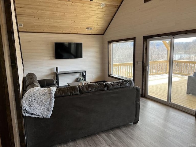 living room with hardwood / wood-style flooring, wood ceiling, and vaulted ceiling