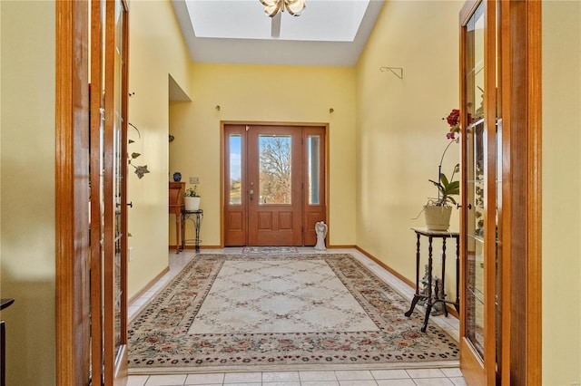 tiled entrance foyer featuring a skylight