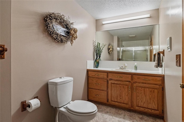 bathroom featuring a textured ceiling, vanity, toilet, and an enclosed shower